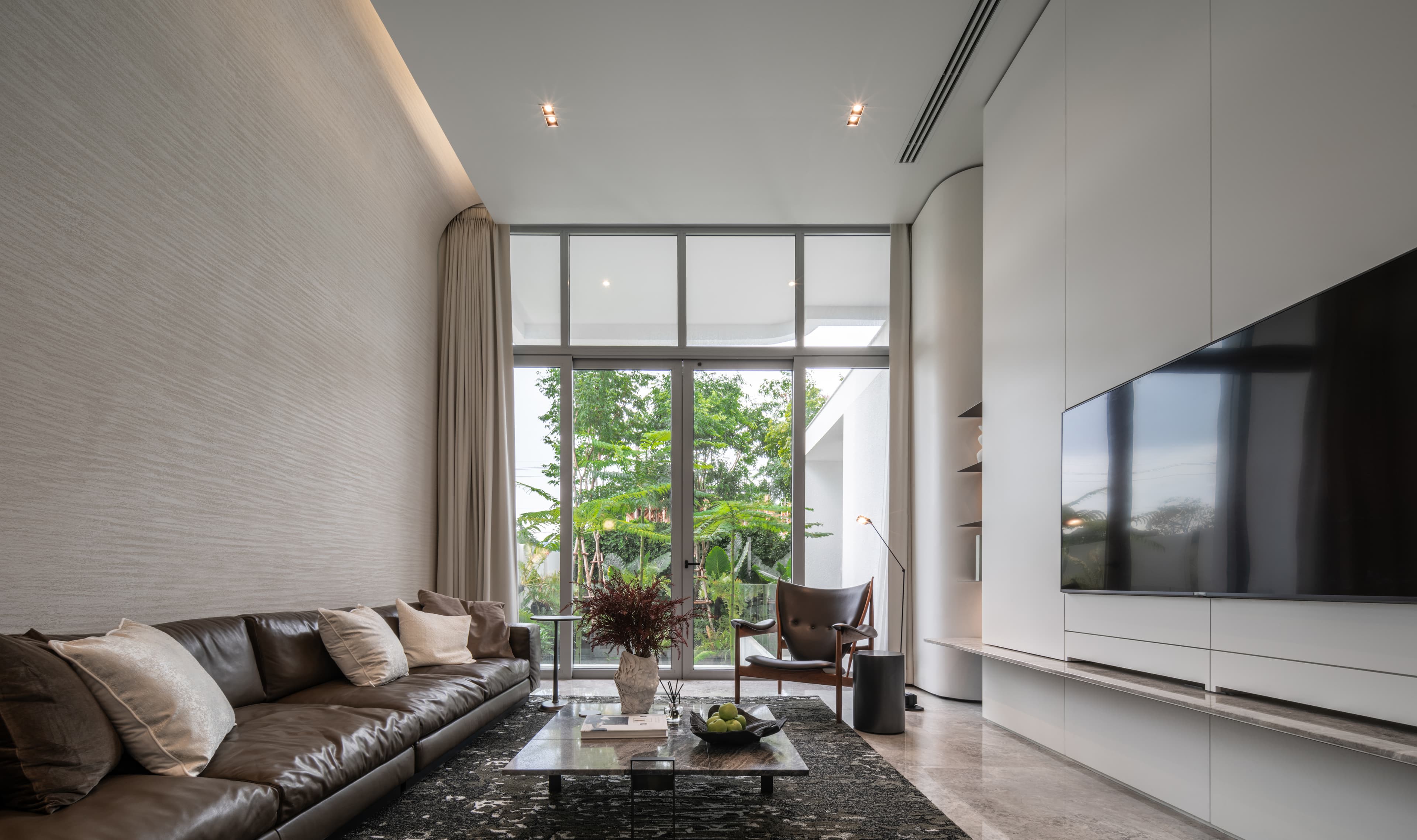 Double-height living room with garden view
