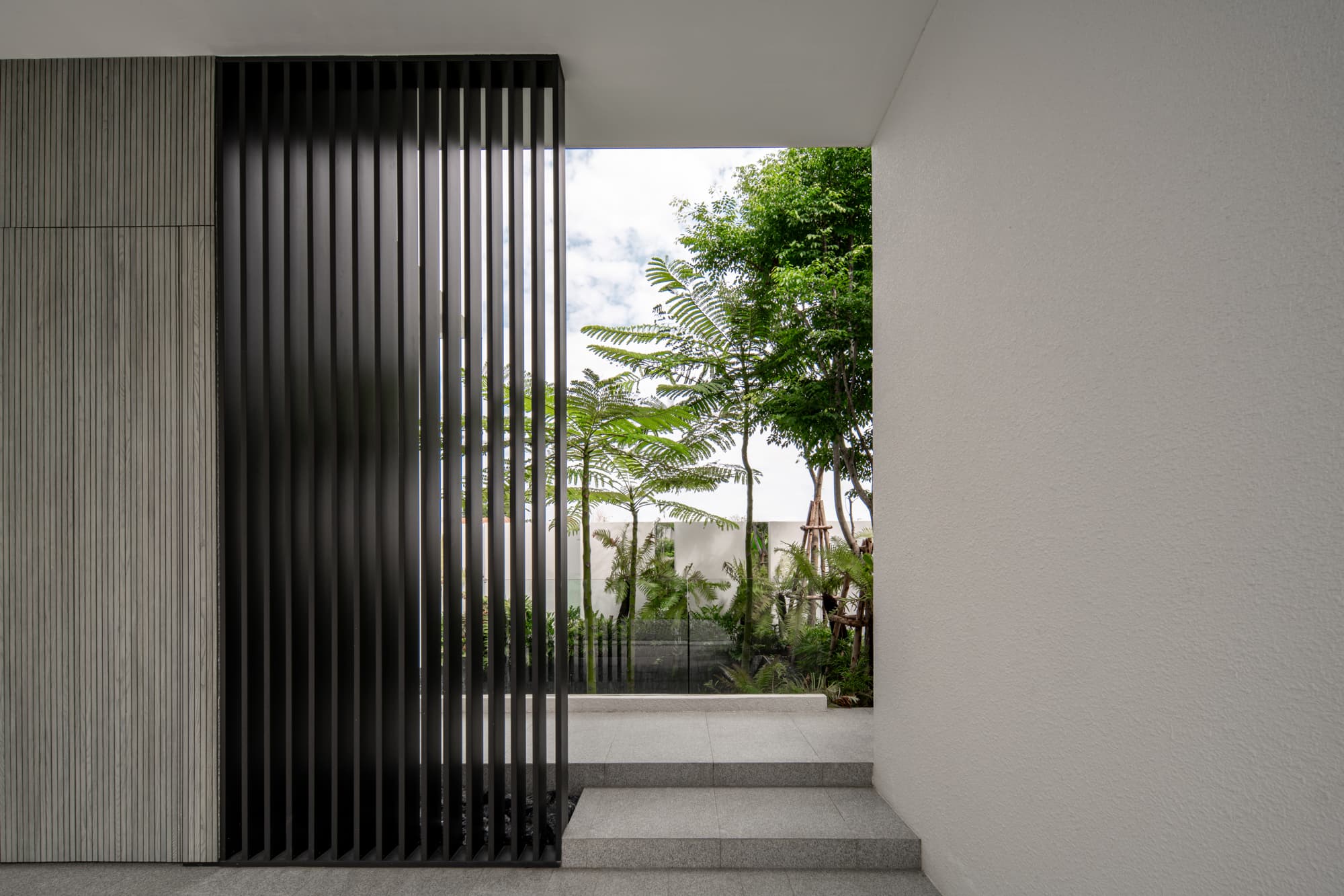 L2 facade — cantilevered white volume with cascading greenery