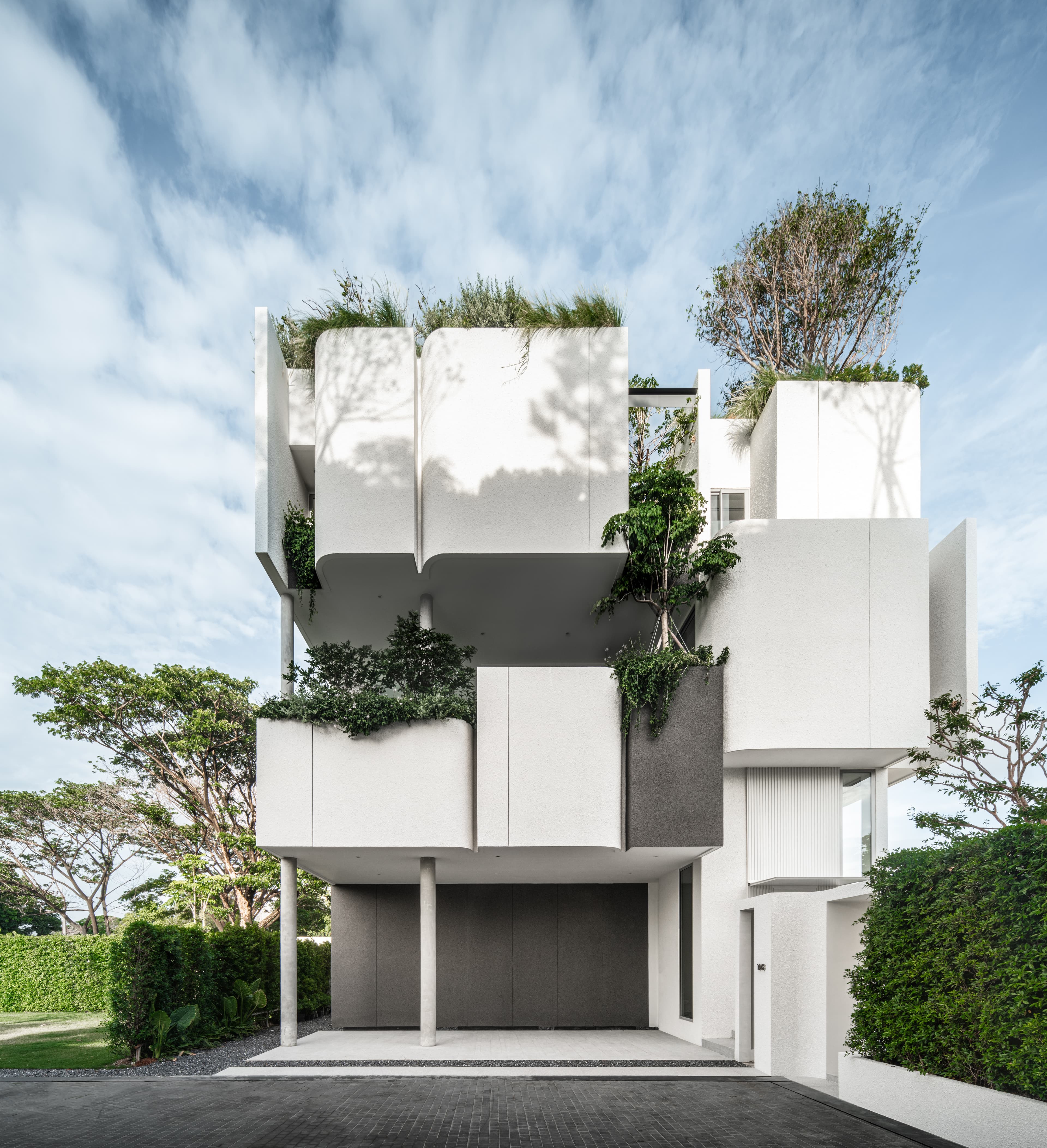 M-House — stacked white volumes with rooftop garden